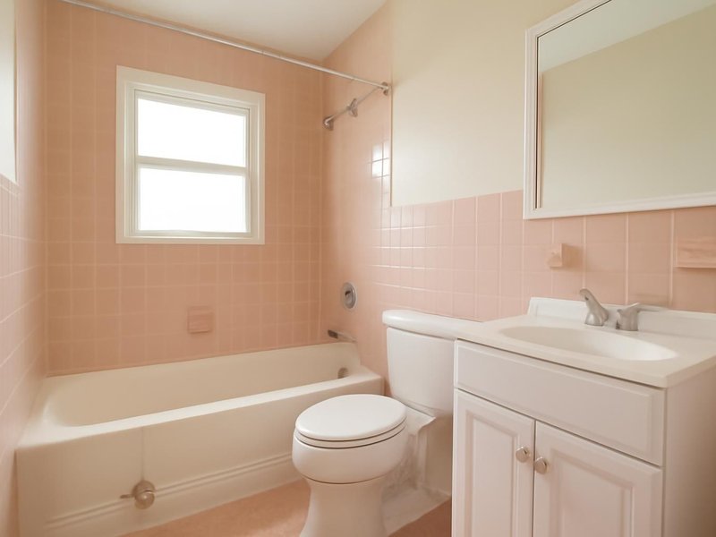 AI concept: Existing condition: pink tile hall bathroom with a chipped tub