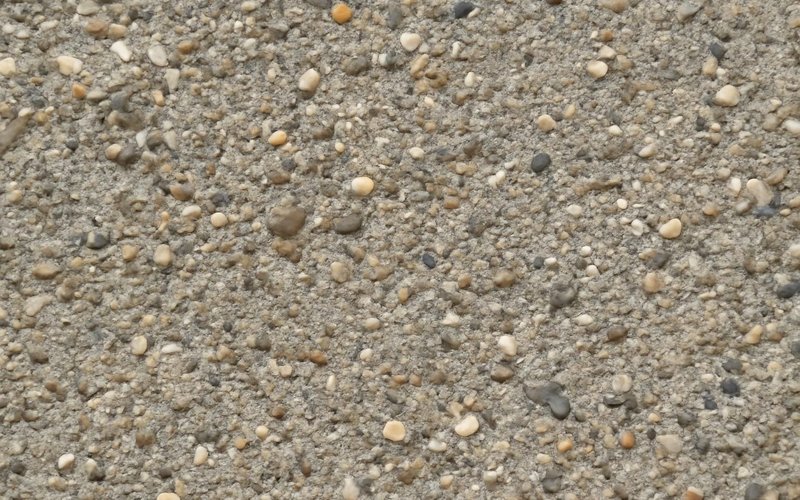 AI concept: Exposed aggregate concrete surface close up