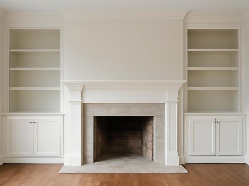 AI concept: Remodeled idea: painted bookcases with cabinet doors on both sides of the fireplace