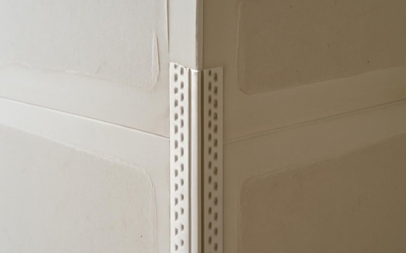 AI concept: Paper-faced metal corner bead on a drywall corner