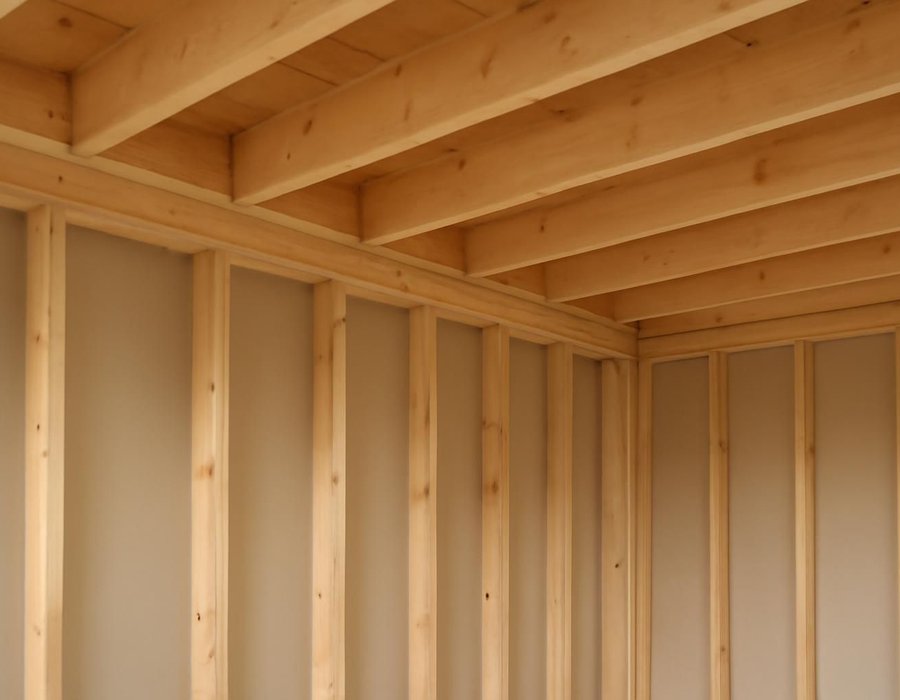 AI concept: Open ceiling showing joists resting on top of a wall, next to joists running parallel to a wall