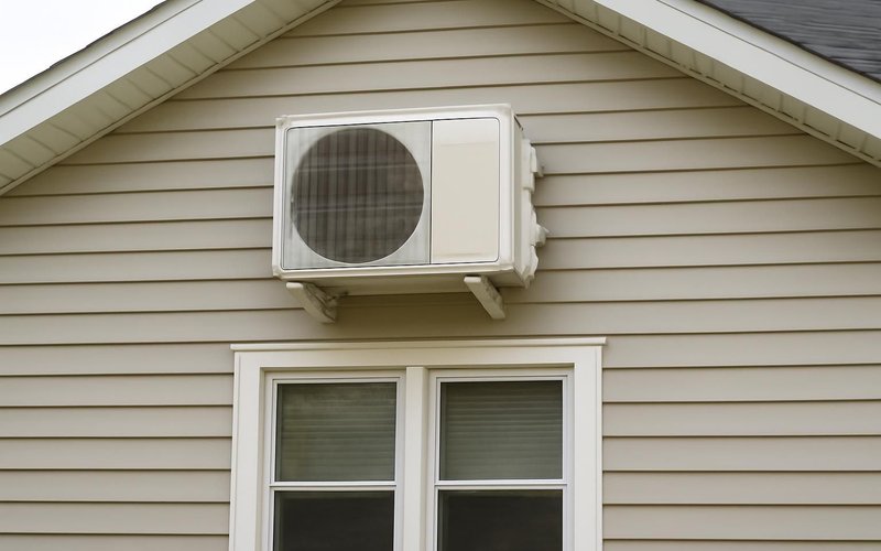 AI concept: Mini-split head above a garage apartment window