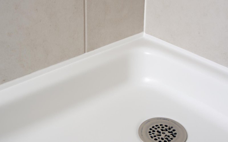 AI concept: Fresh silicone caulk bead along a shower