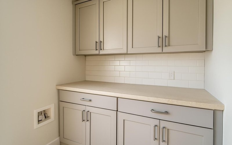AI concept: Wall and base cabinets in a laundry room