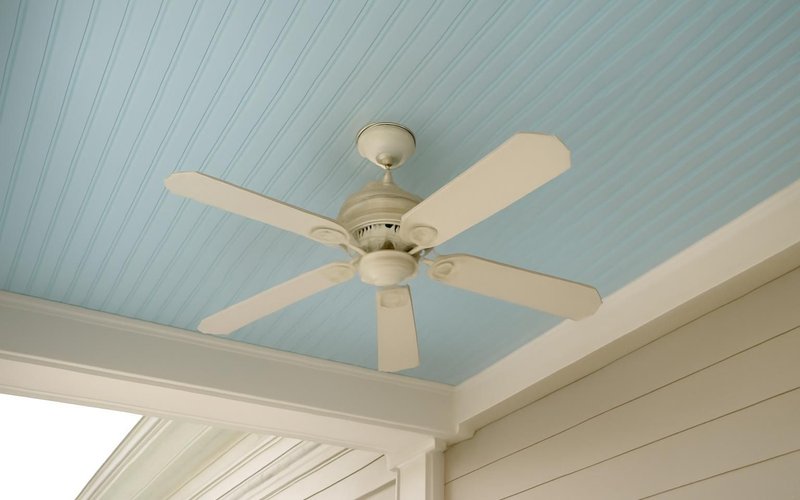 AI concept: Pale blue beadboard porch ceiling with a ceiling fan