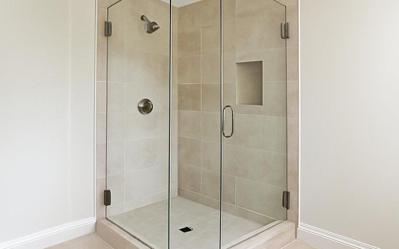AI concept: Frameless glass shower enclosure with brushed hardware