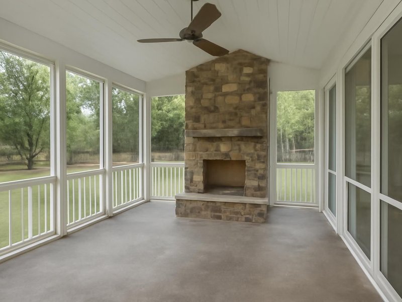 After: screened porch with a stone fireplace and removable winter panels