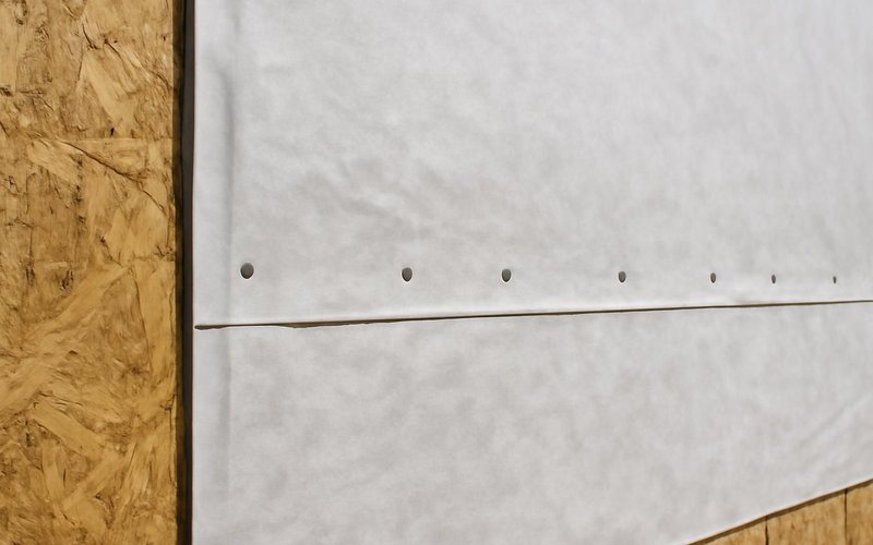 AI concept: Housewrap installed over sheathing on a new wall