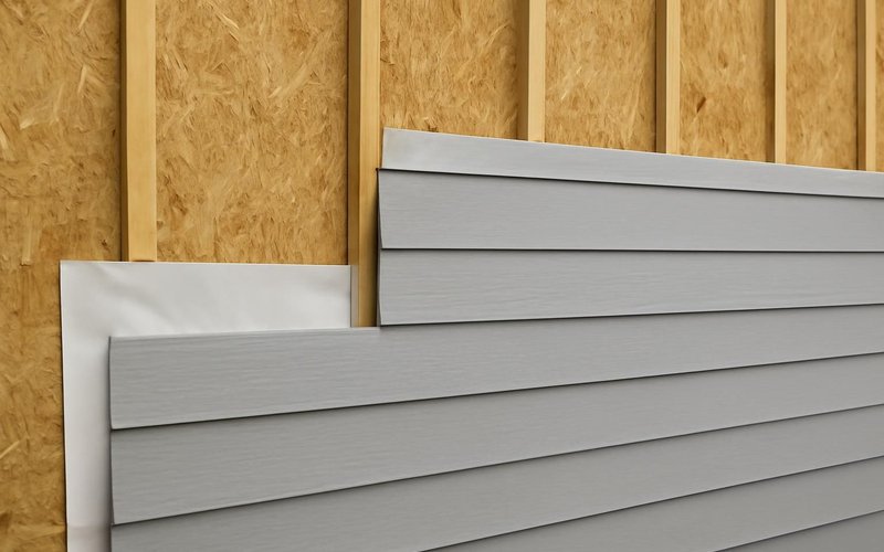 Fiber cement lap siding going onto a rebuilt wall