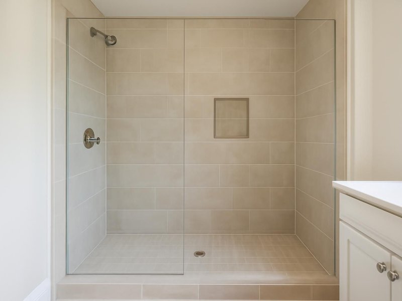 AI concept: Remodeled idea: 48-inch tiled shower with a fixed glass panel and niche