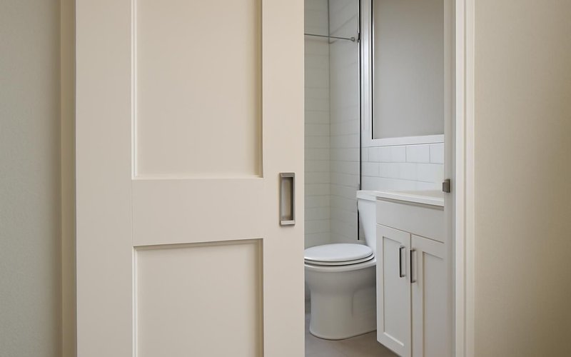 AI concept: Pocket door sliding into a bathroom wall