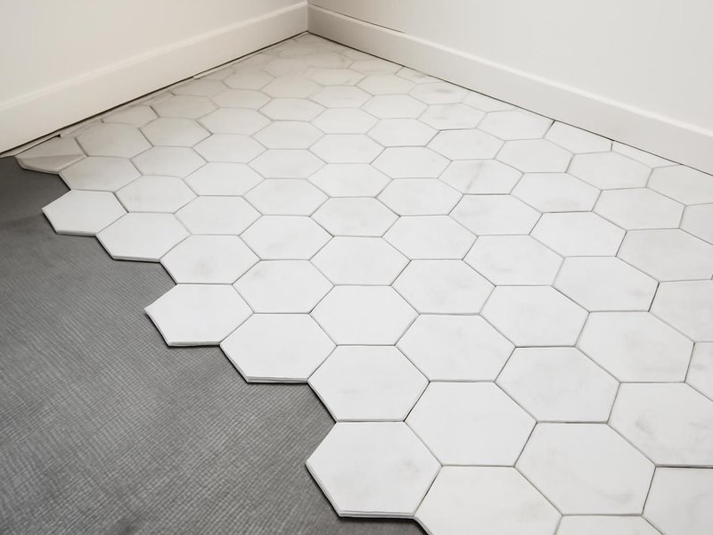 After: hexagon marble-look porcelain over a new membrane