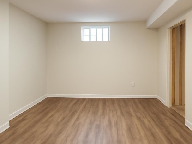 After: basement dried, walls rebuilt and new vinyl plank floor